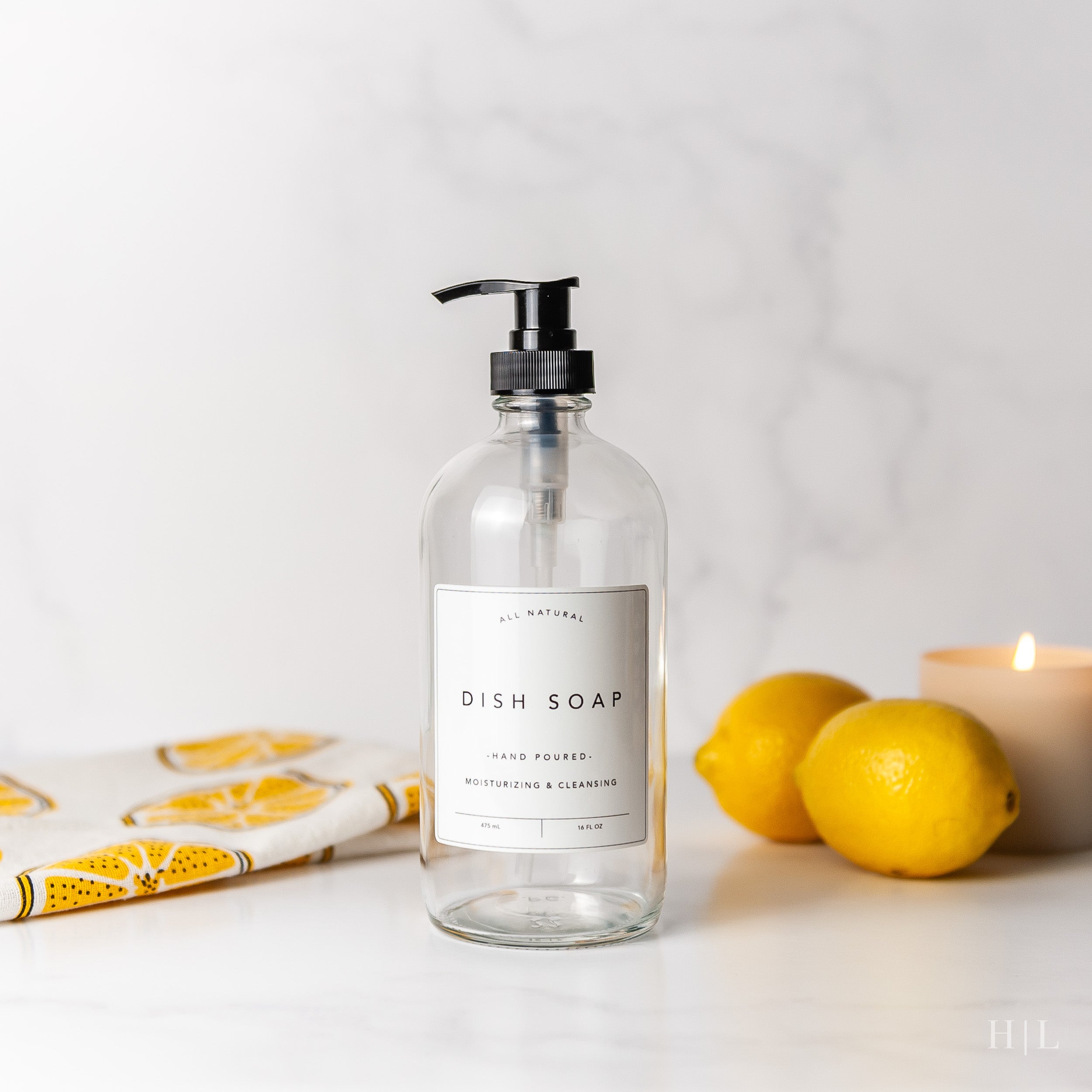 a bottle of dish soap next to some lemons