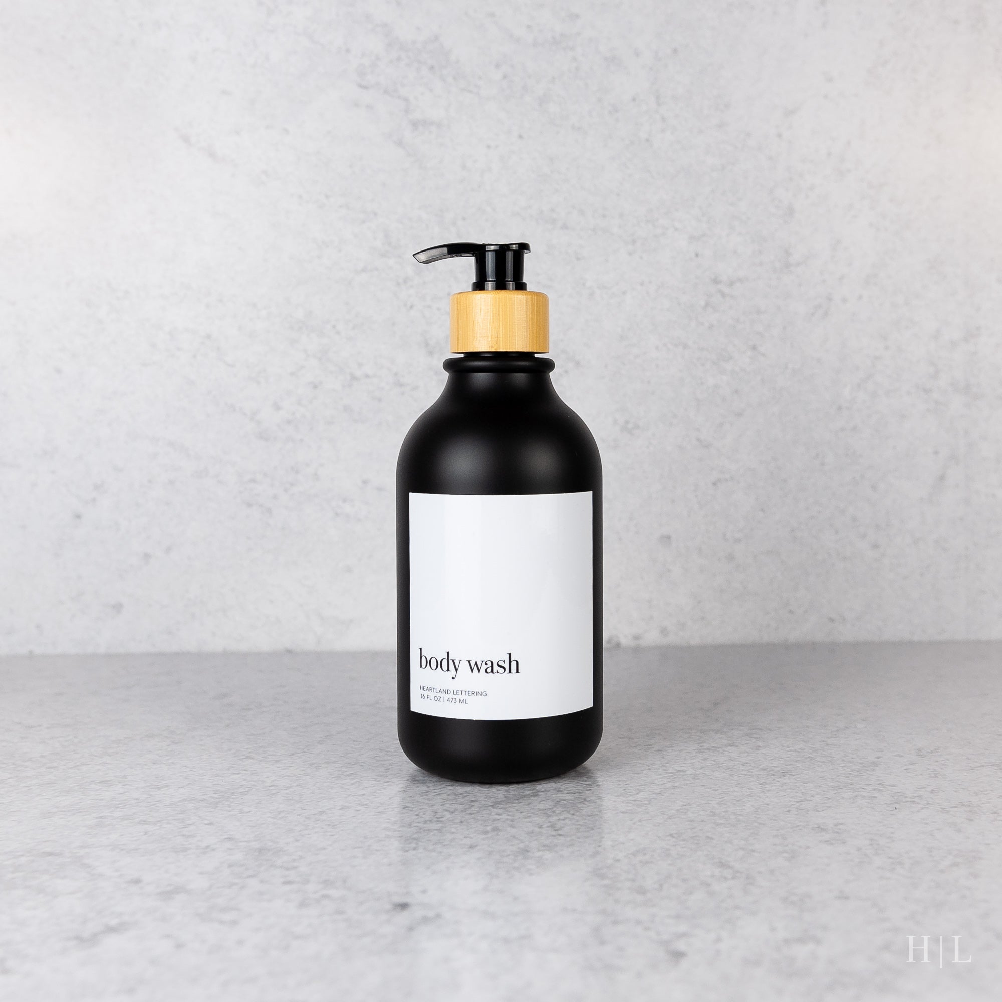 a black bottle with a white label on it