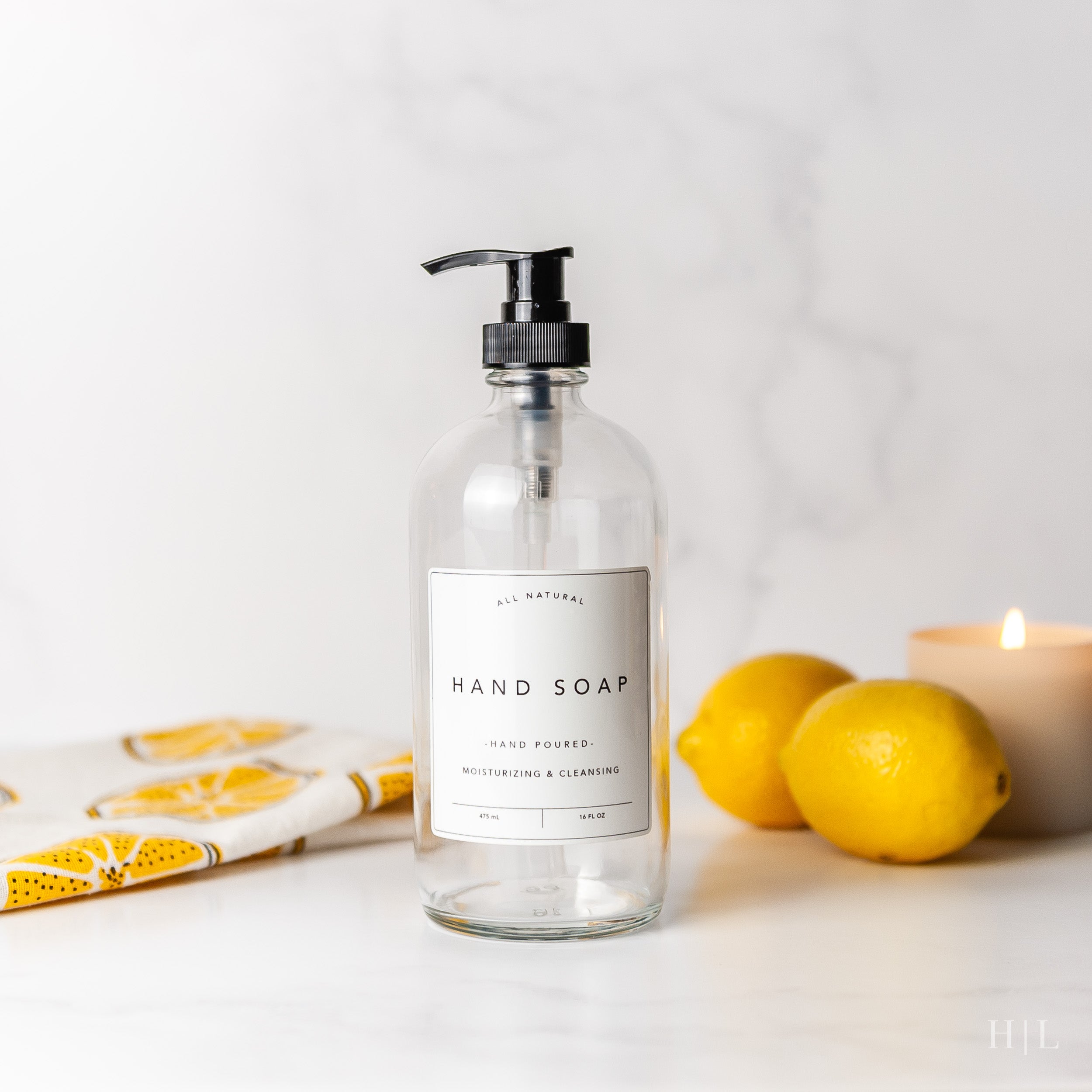 a bottle of hand soap next to some lemons