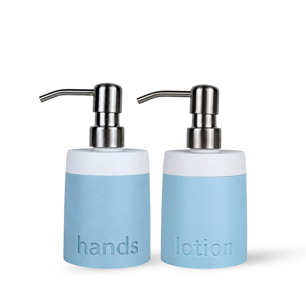 Two cylindrical pump bottles for hands and lotion in a light blue and white color scheme, with chrome pumps, on a white background.