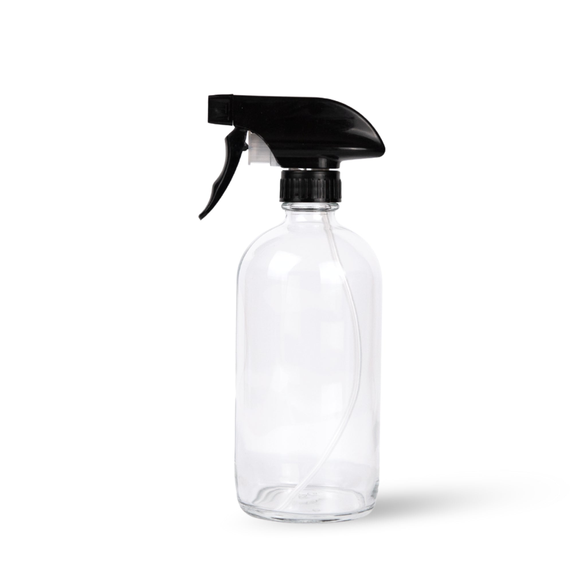 A clear glass spray bottle with a black trigger nozzle, designed for refilling and versatility in use.