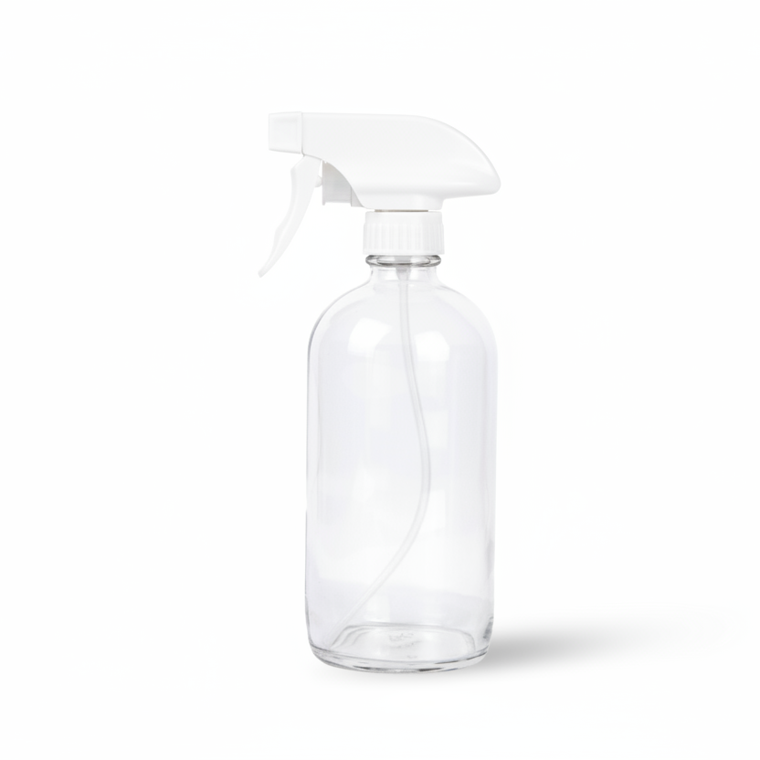 A clear glass spray bottle with a white plastic trigger sprayer, shown on a clean white background with a soft shadow.