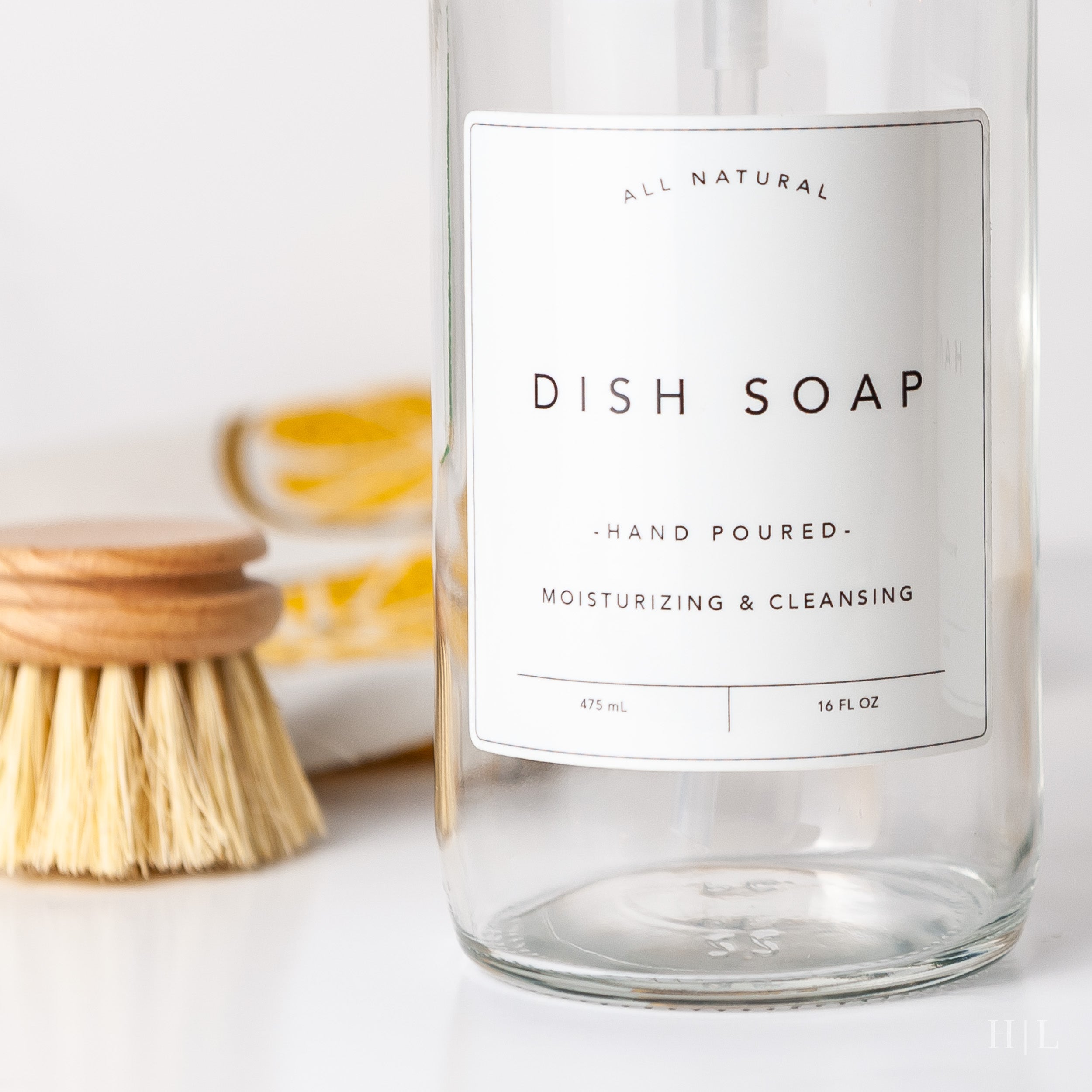 a bottle of dish soap next to a brush