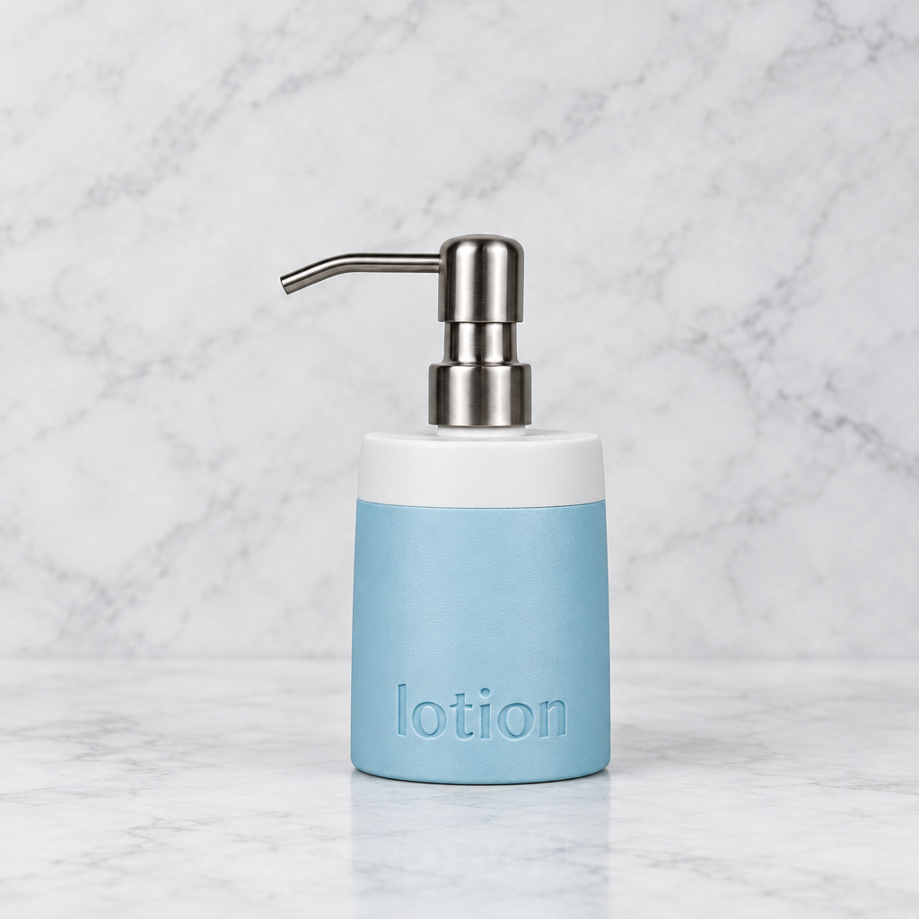 A light blue and white lotion bottle with a brushed silver metal pump dispenser, standing on a white marble surface against a white marble background.