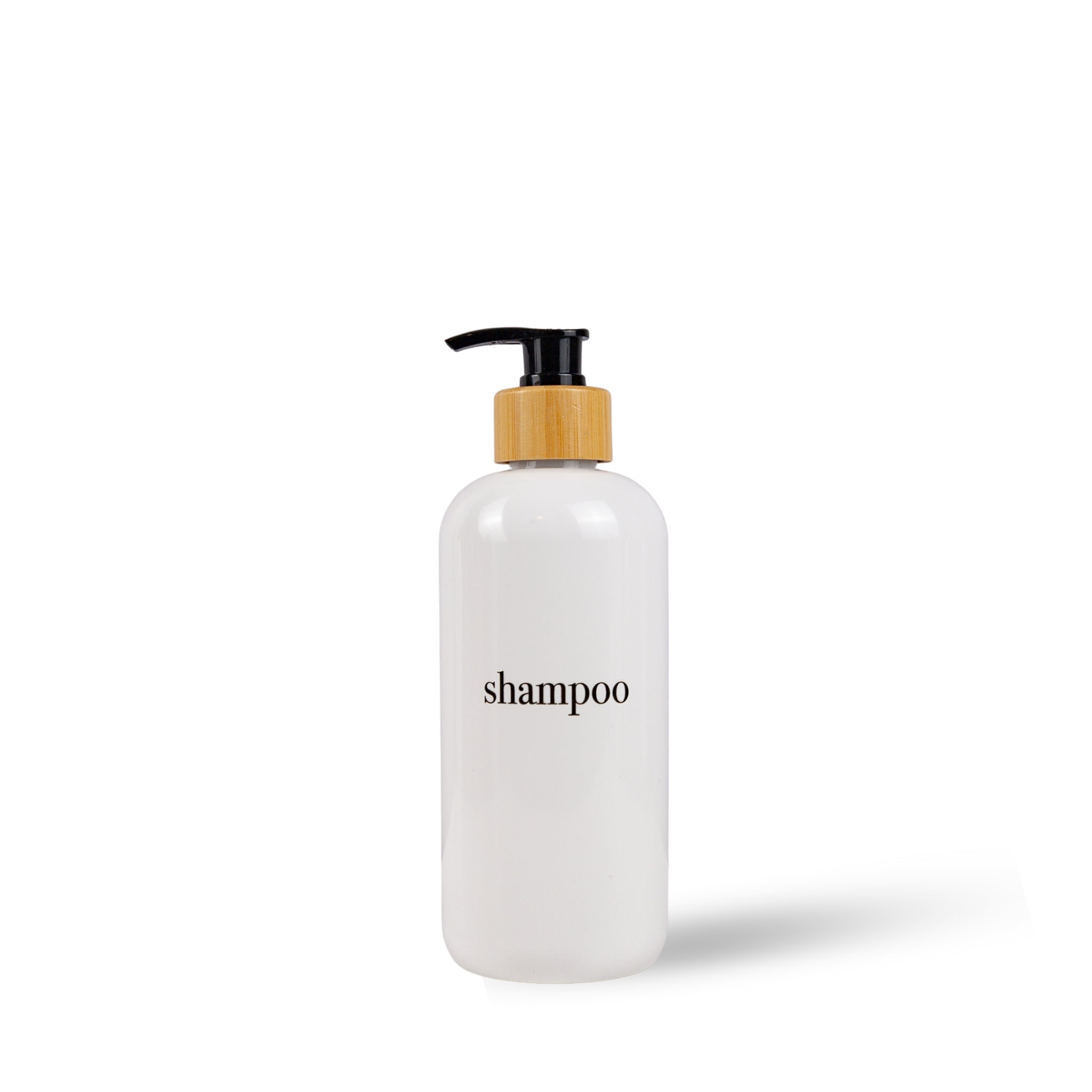 White shampoo bottle with a wooden pump on a white background