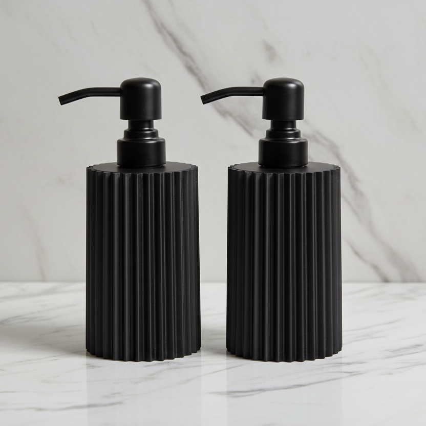 Two black ribbed soap dispensers on a marble surface with a light gray background