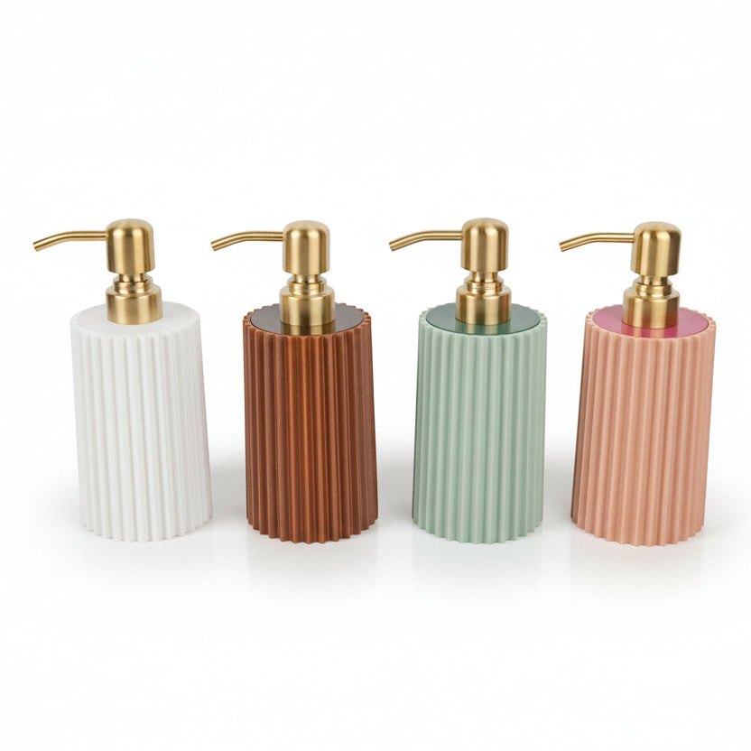 Four ribbed soap dispensers with gold pumps in white, brown, green, and pink on a white background.