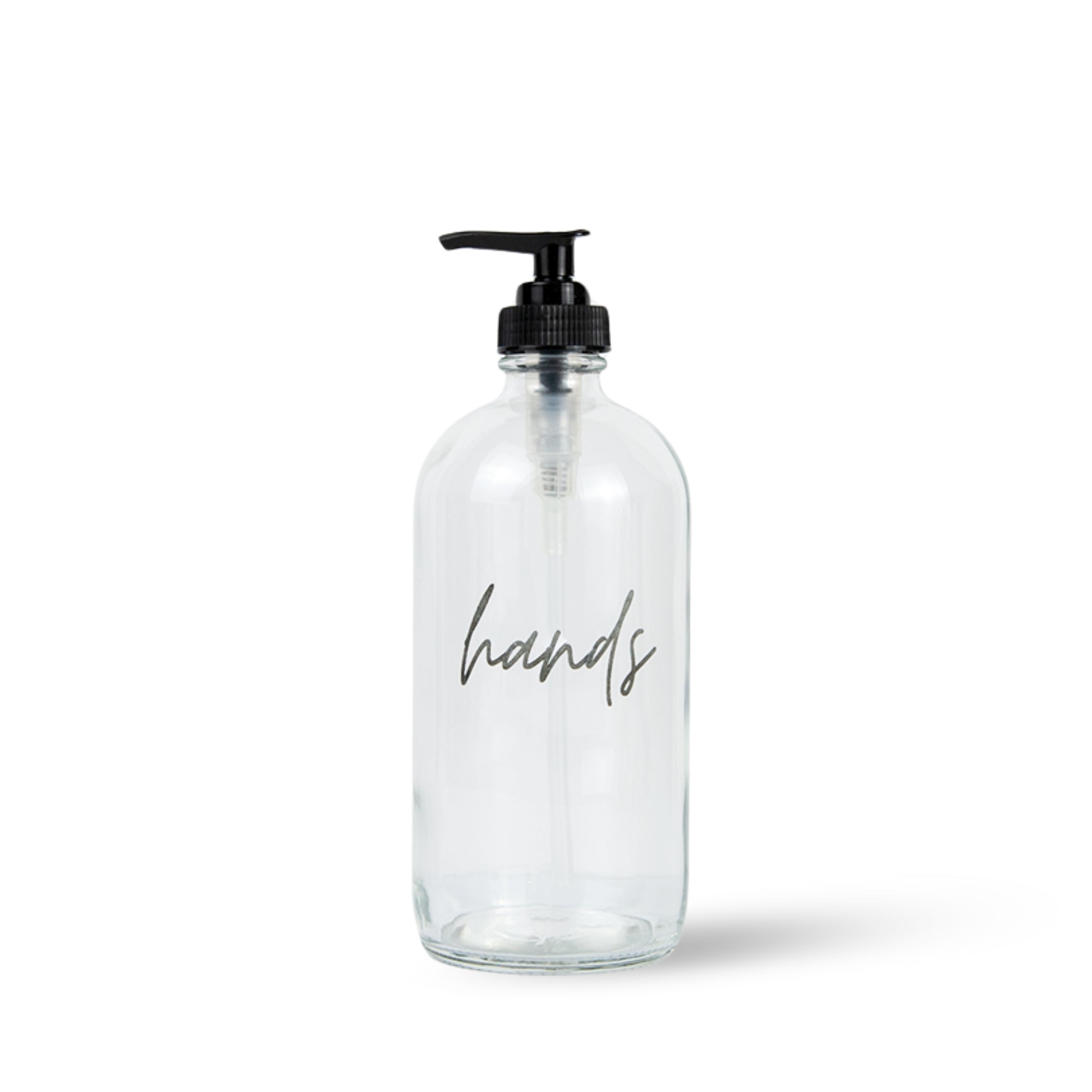 Clear hand soap bottle with black pump and 'hands' script classic farmhouse text on a white background