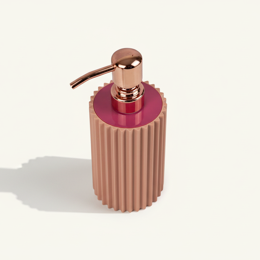 Decorative bottle with ribbed design and rose gold pump on a white background