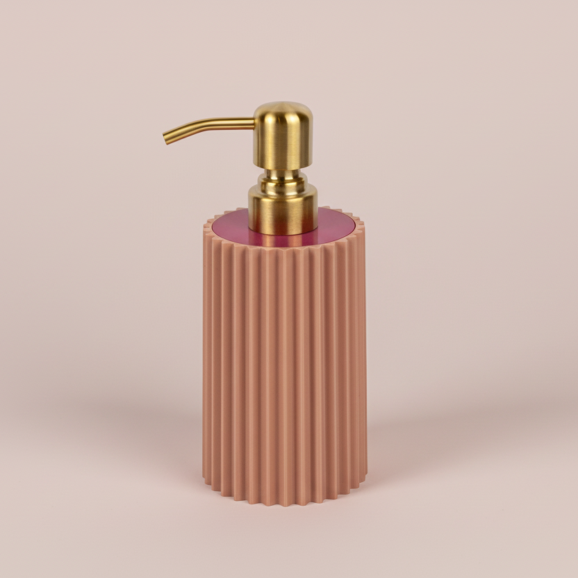 Pink ribbed soap dispenser with gold pump on a beige background
